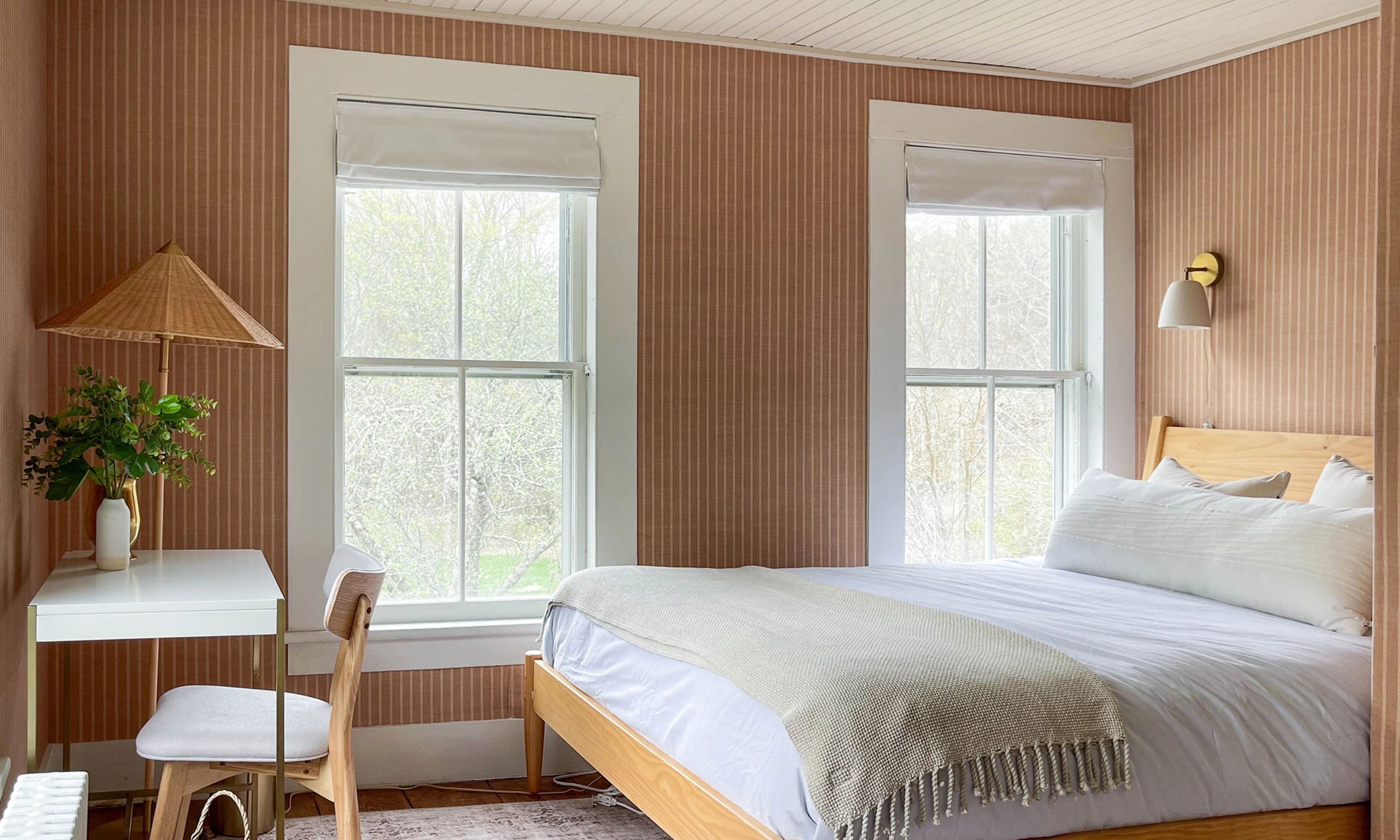 Bedroom with mauve striped wallpaper.