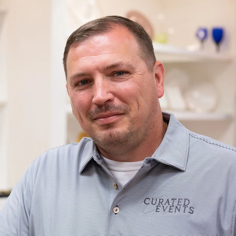 Headshot of a white male in a polo with CURATED EVENTS embroidered on it.