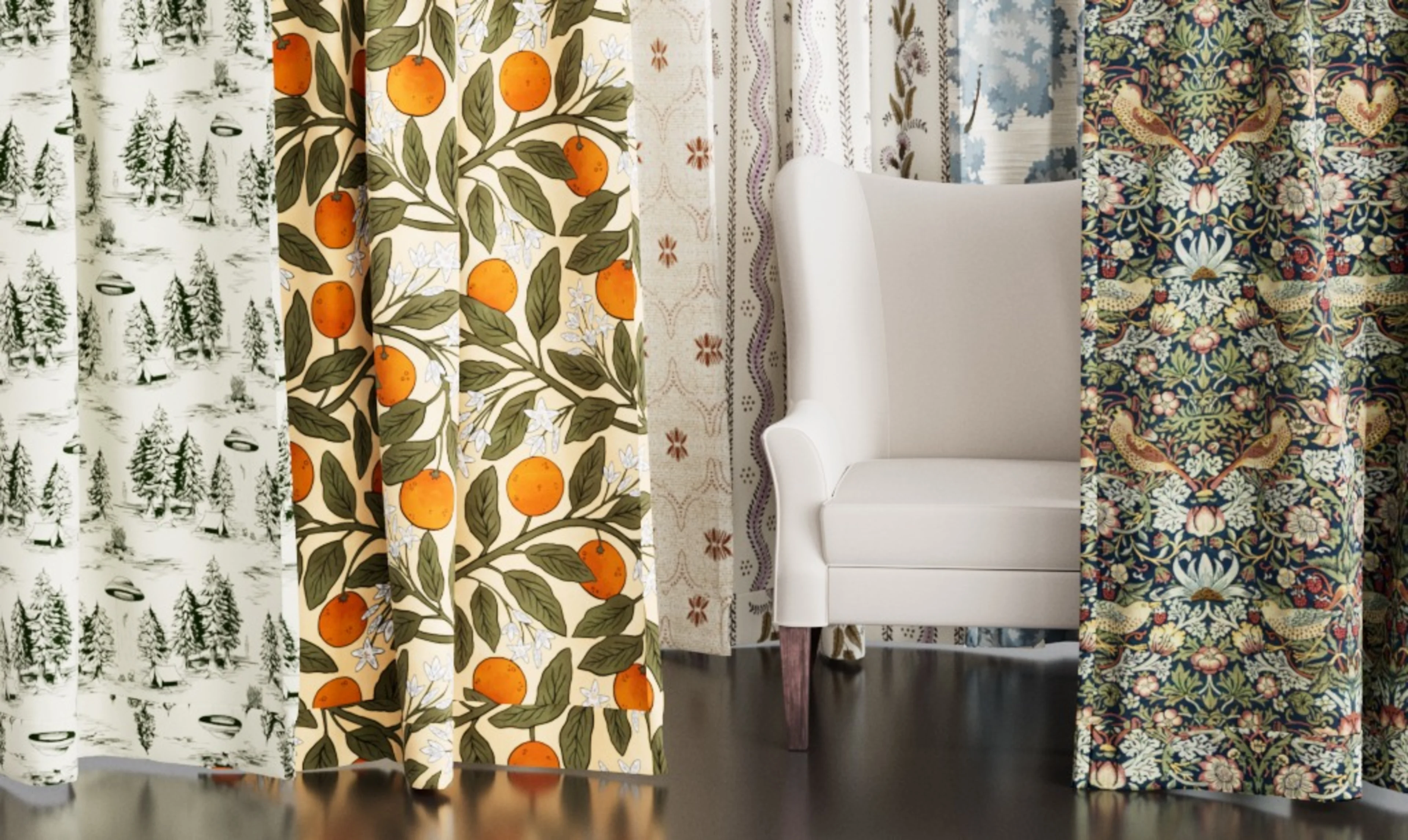 Multiple colorful curtains hanging around a chair with throw pillows