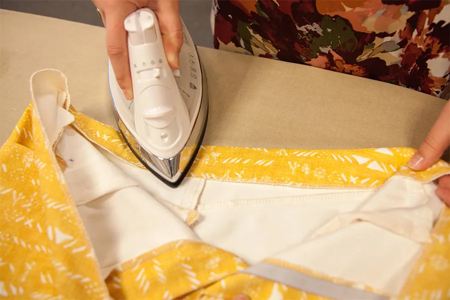 MaryAshlyn ironing the waistband after turning the pieces right side out.