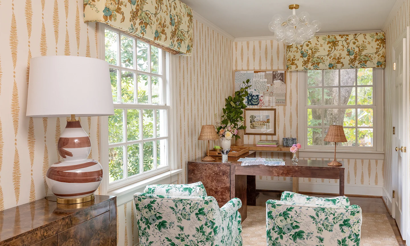 Caroline Walkers home office with stripe wallpaper and floral drapery and chairs.