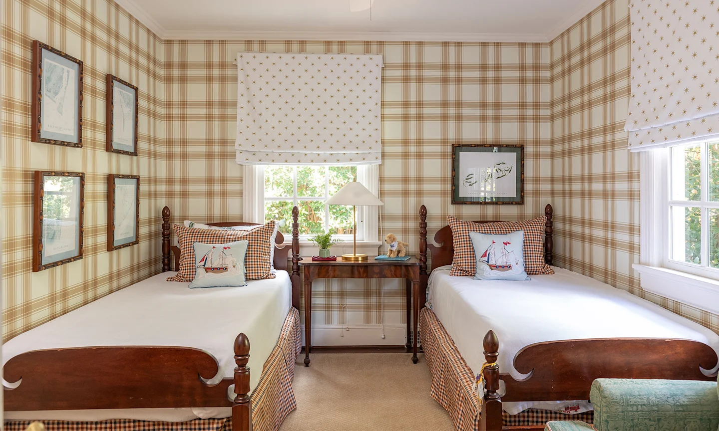 Bedroom with tan plaid wallpaper and two twin beds.