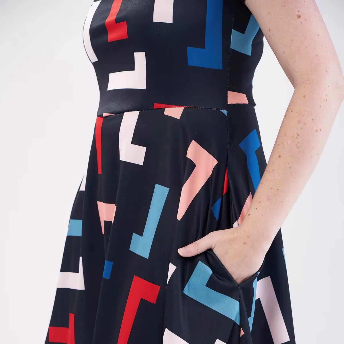 A model wearing an abstract print dress made with Sport Pique