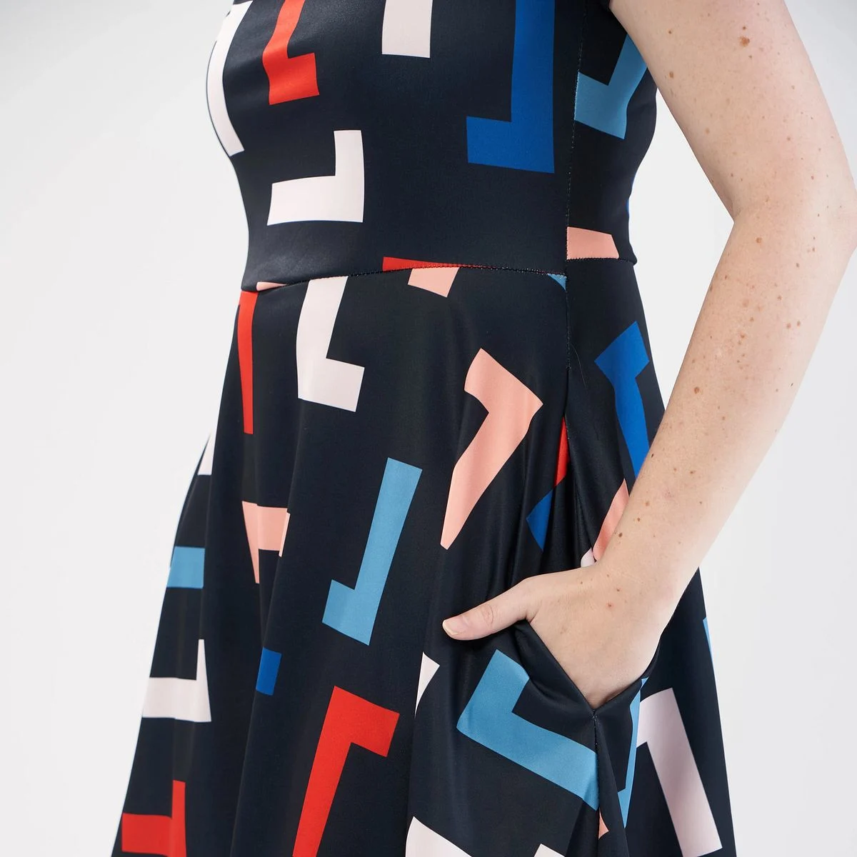 A model wearing an abstract print dress made with Sport Pique