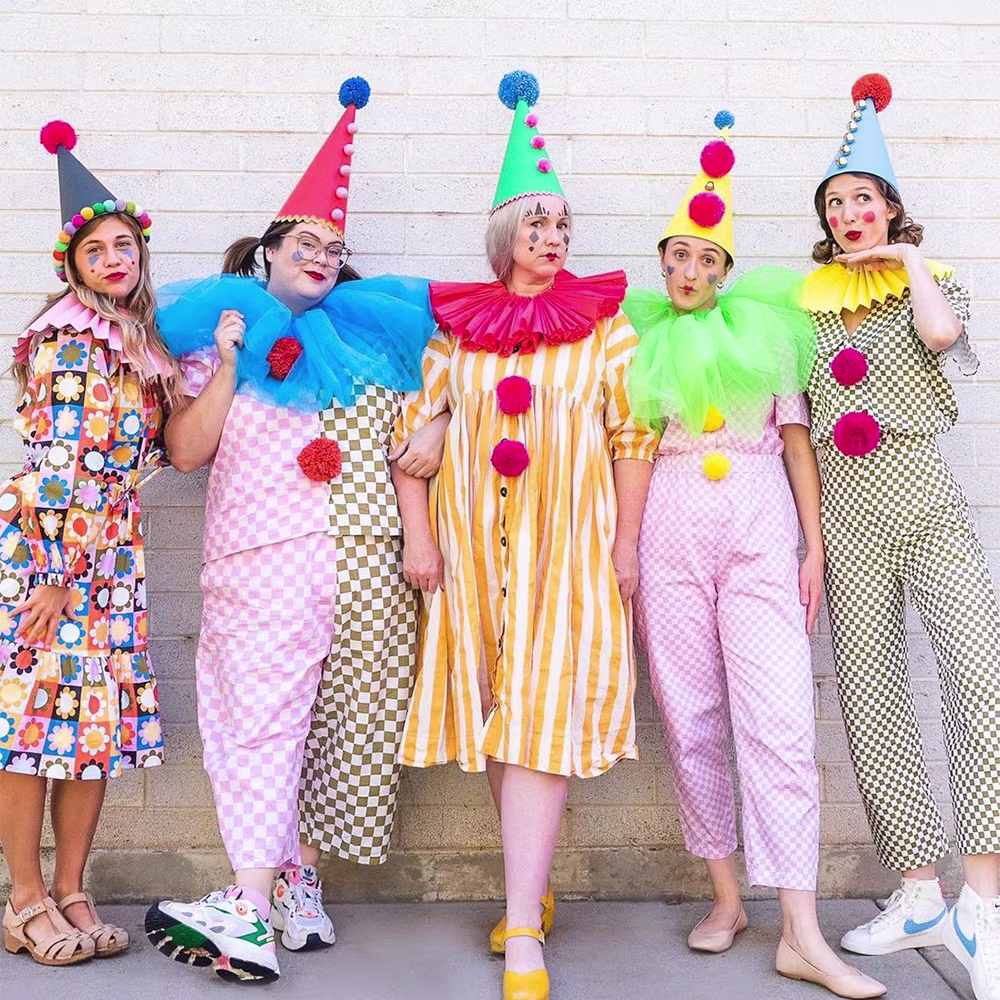Five people in outfits made with The House That Lars Built Designs and clown hats & collars.