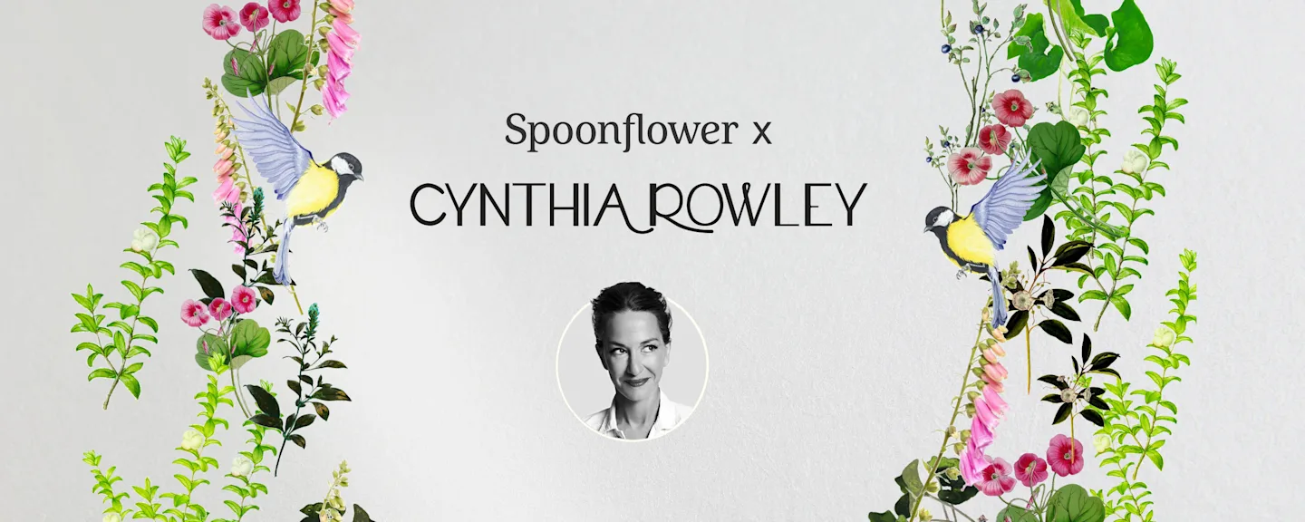 A sofa with wooden trim is placed against a floral-patterned wall and a headshot of Cynthia Rowley.