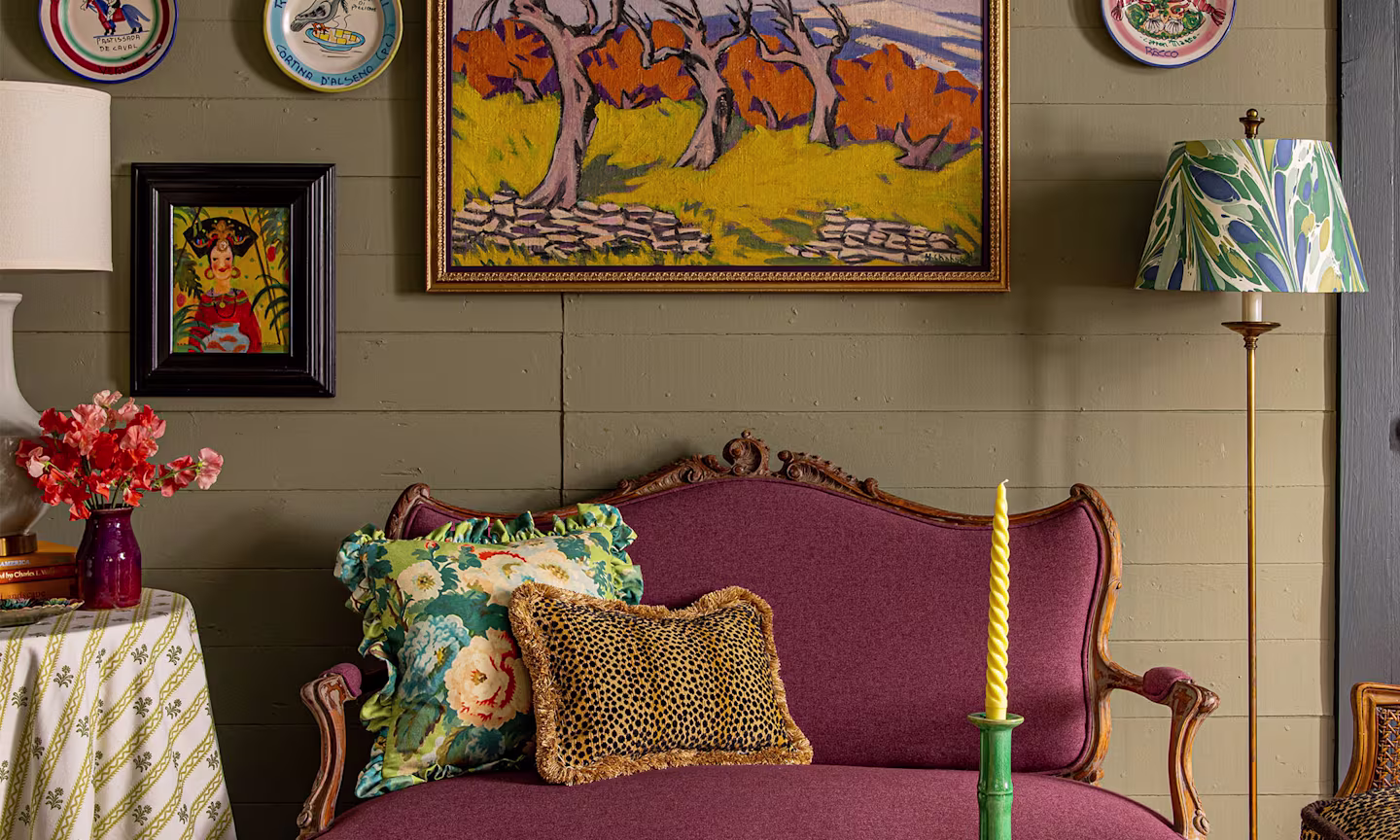 living area with a settee pillows and decor.