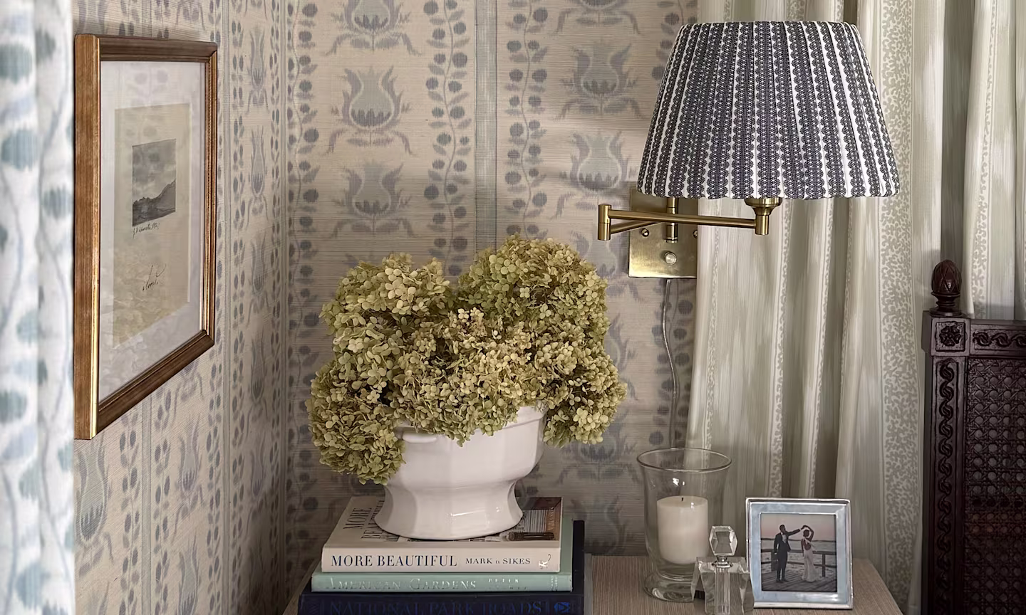 Bedroom wall with grasscloth pomegranate stripe wallpaper.