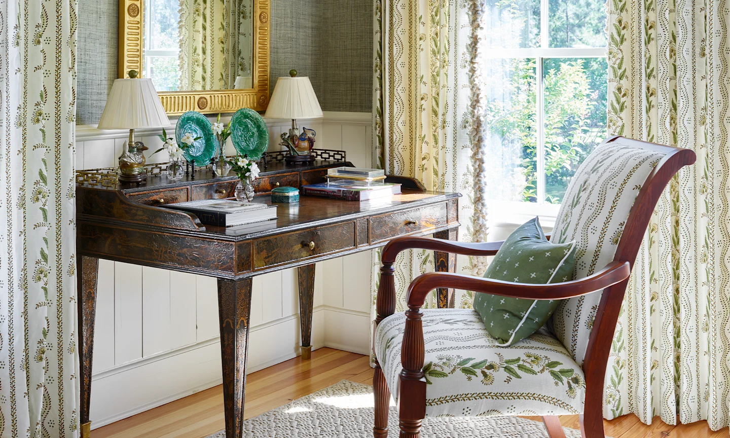 A staircase wallpapered with traditional styled green stripes.