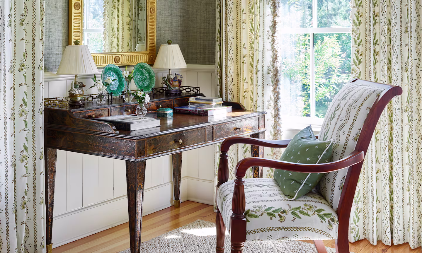 A staircase wallpapered with traditional styled green stripes.