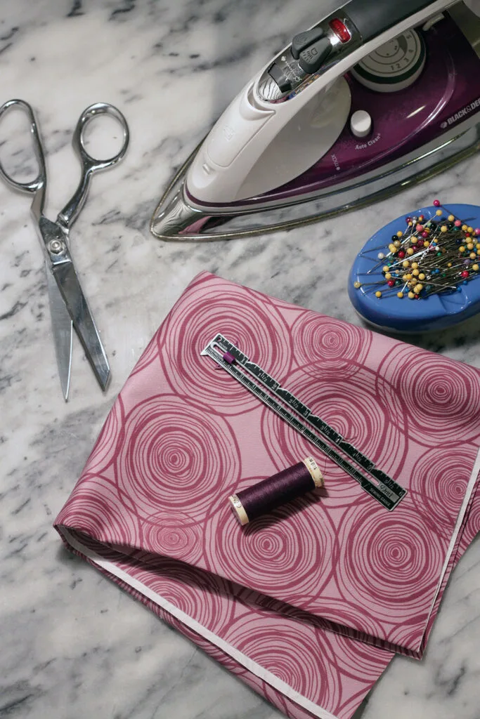 supplies needed: image shows an iron, scissor, pins, fabric, seam guide and thread