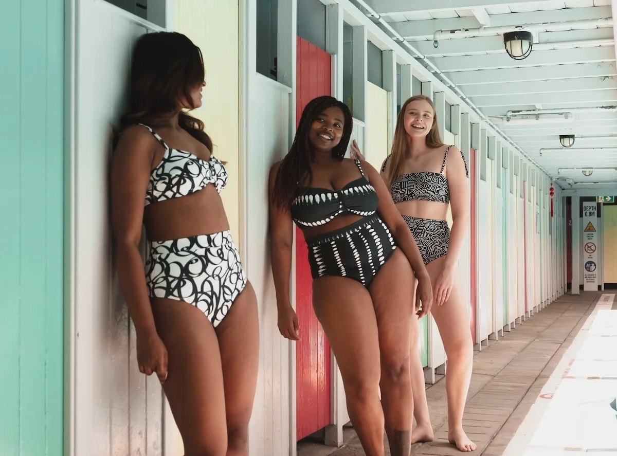 Three models wearing coordinating black and white swimsuits made with Sport Lycra