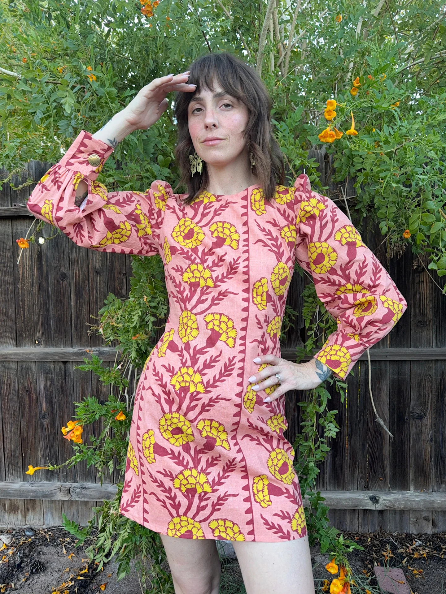 Kelsey Garner in a bright yellow and pink boho dress