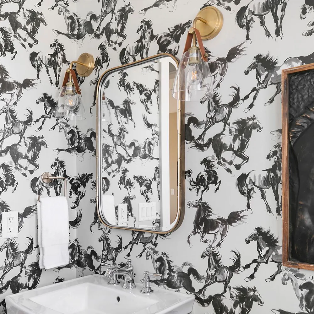 Bathroom with black and white wild horses wallpaper.