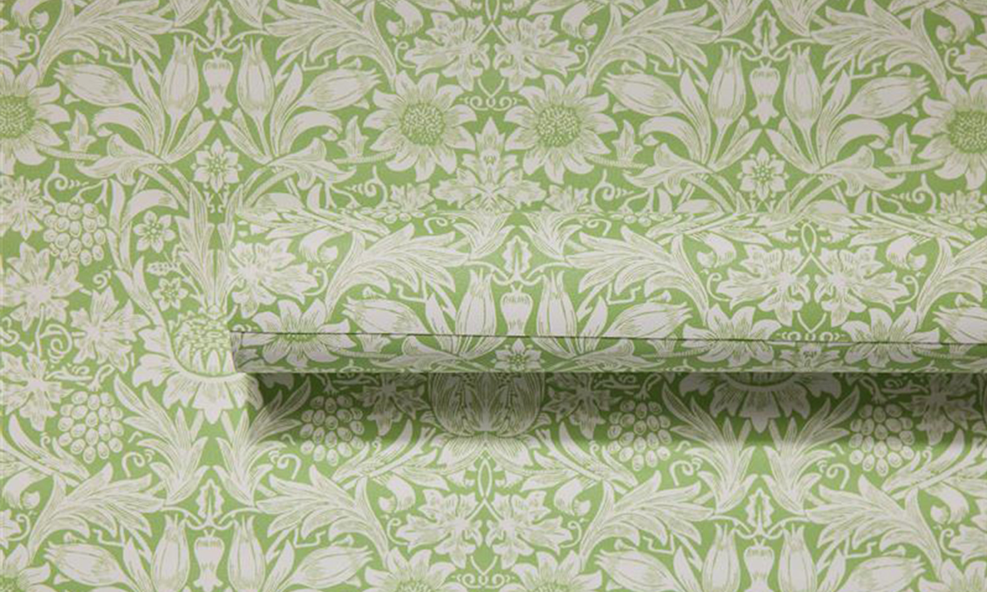 Vinyl wallpaper roll with a green ornate floral design.
