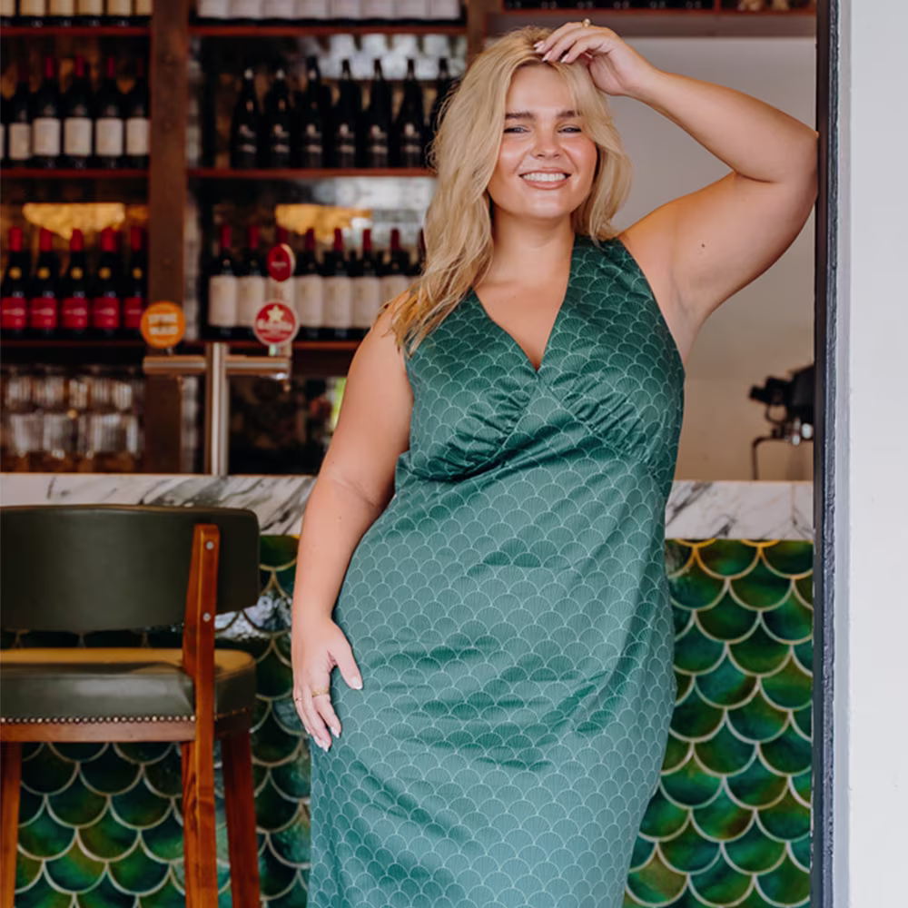 Woman in a teal slip dress.