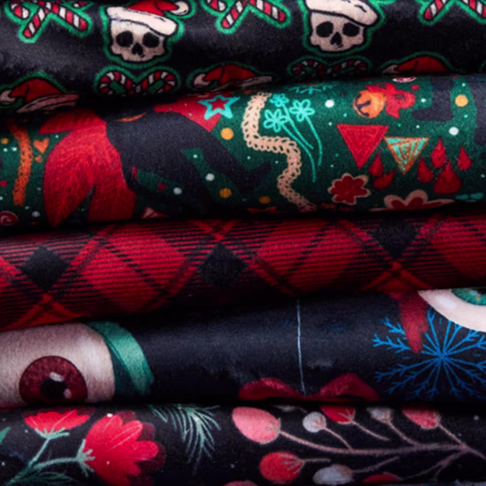 Stack of creepy christmas themed fabrics