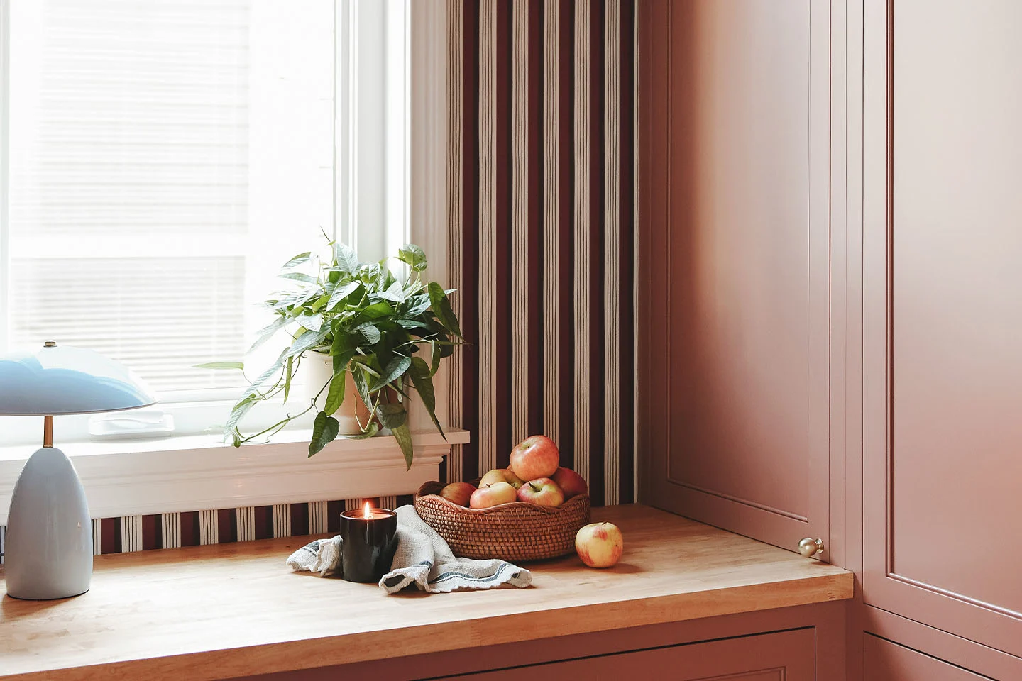 Pantry transformation using Spoonflower wallpaper with bold stripes.