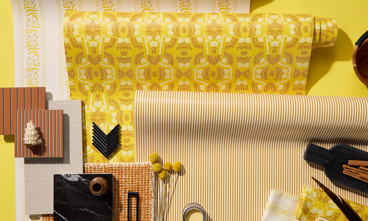 Rolls of yellow wallpaper on a yellow background.
