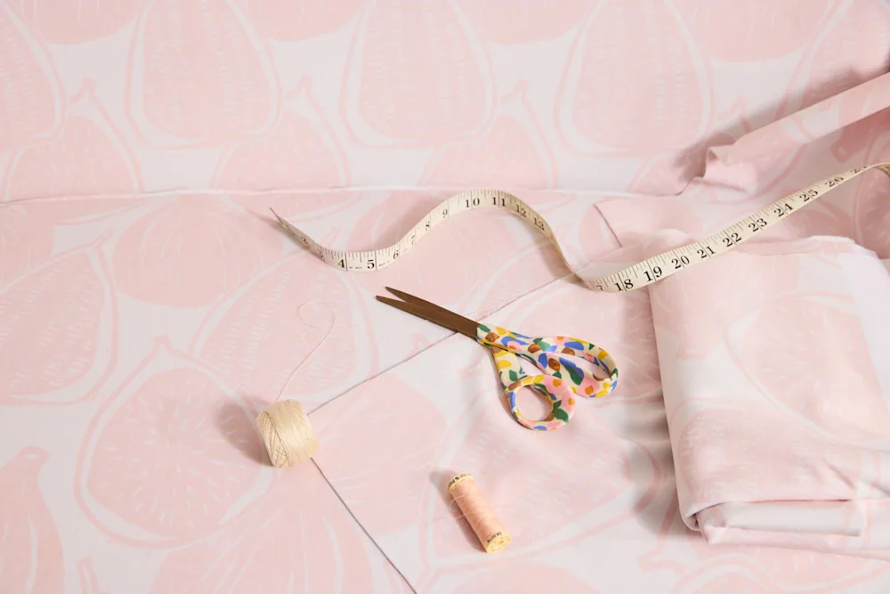 Pink fabric and colorful scissors
