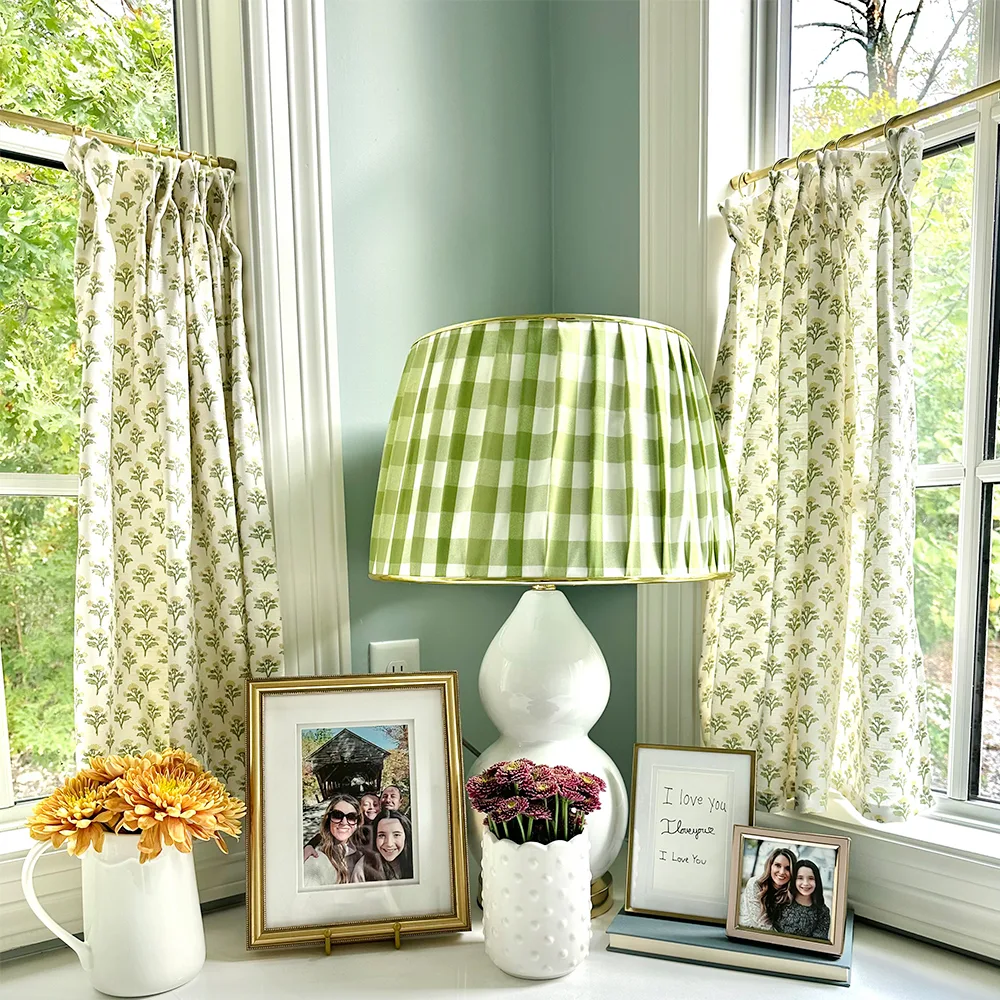 Home office with a gingham lampshade and floral block print cafe curtains.
