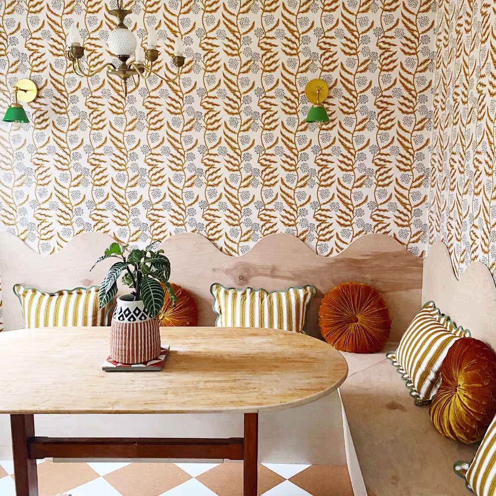 Orange floral fine wallpaper in a kitchen breakfast nook.