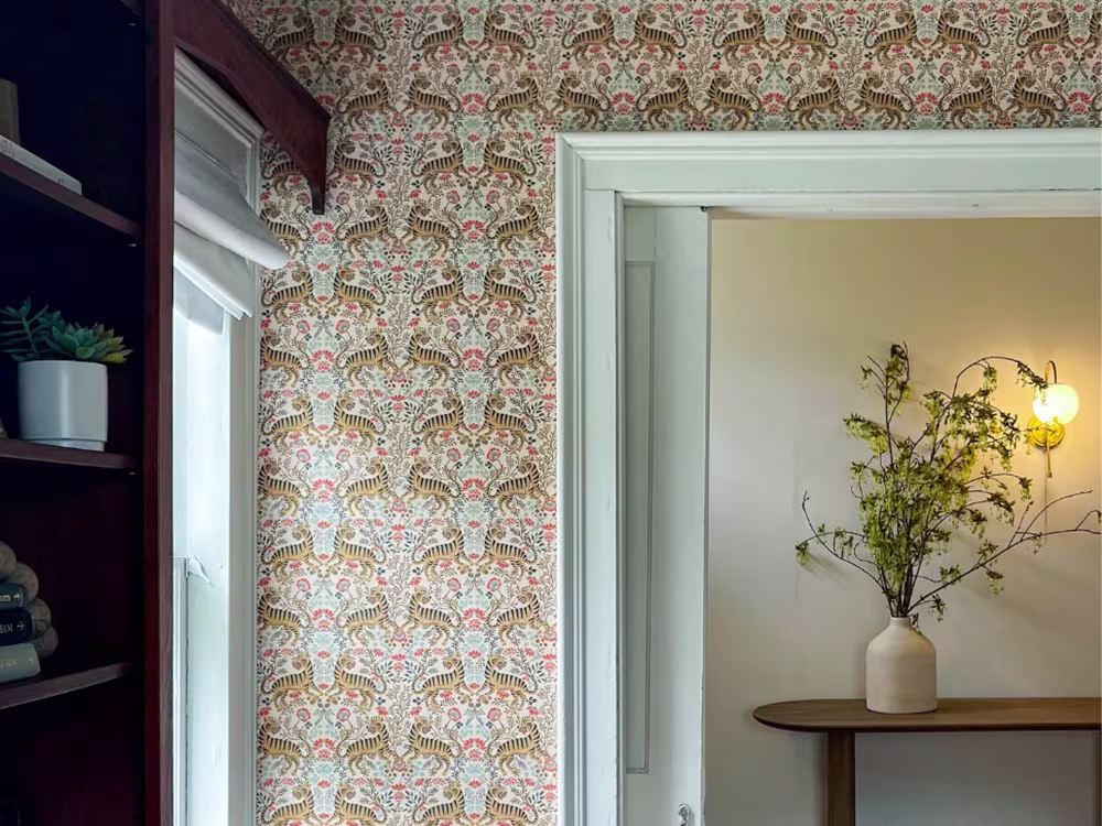 Living space with flower tiger wallpaper.