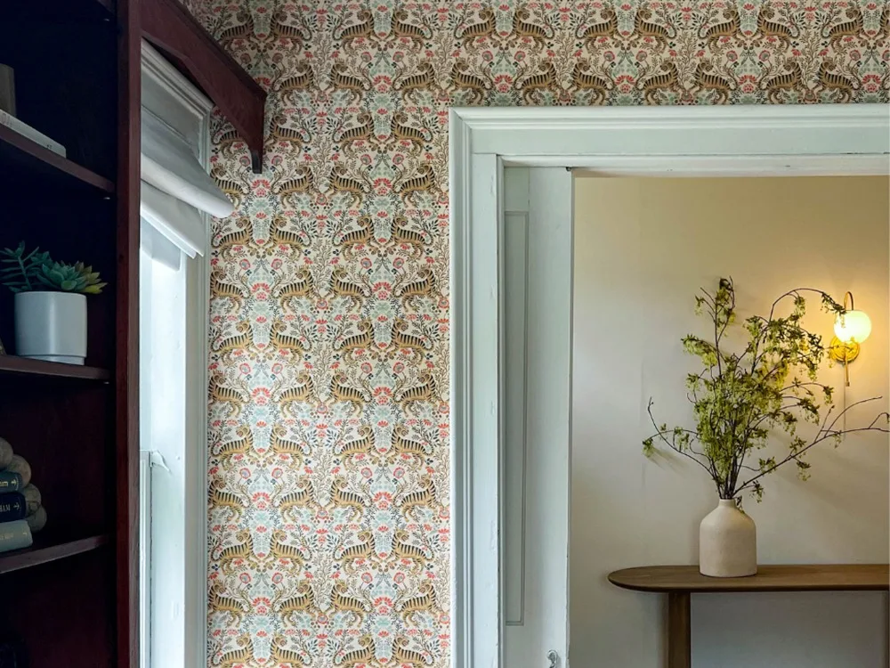 Living space with flower tiger wallpaper.