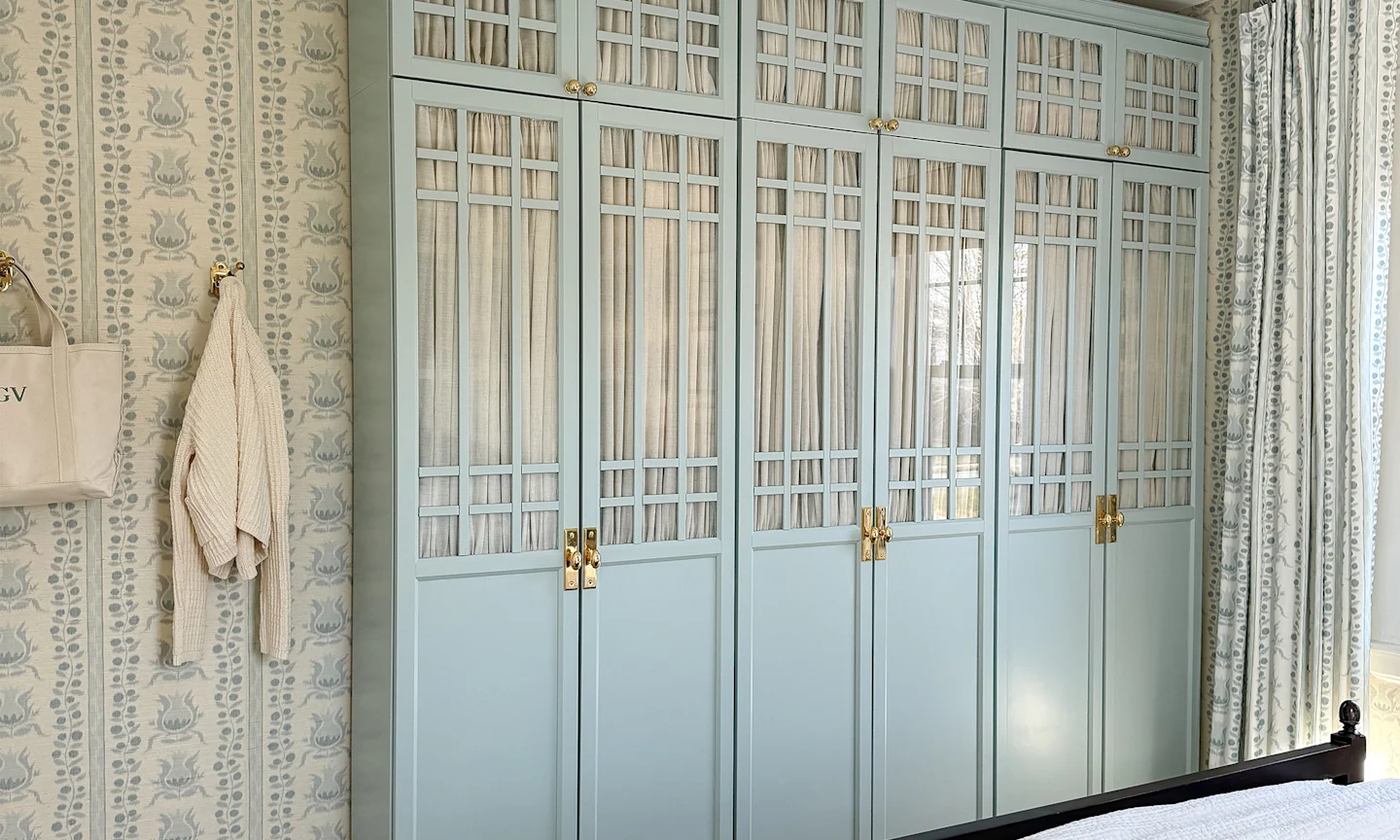 Bedroom with ikat pomegranates wallpaper and coordinating curtains, fabric accents and bedding.