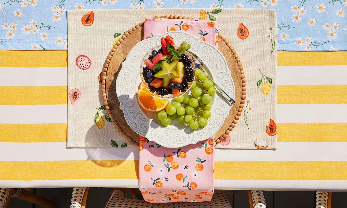 Outdoor dining table with bright and summery dining decor.