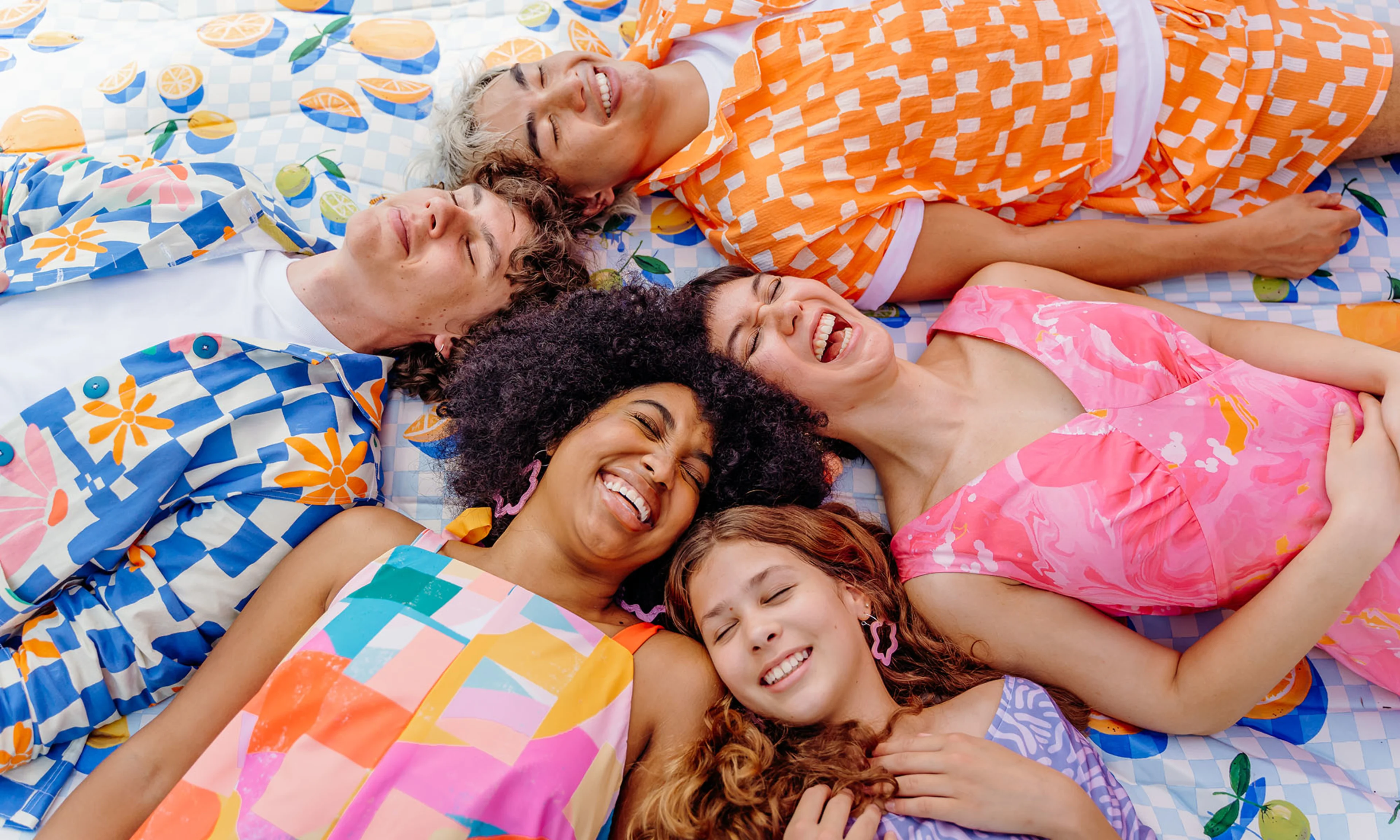 People in colorful outfits giggling.