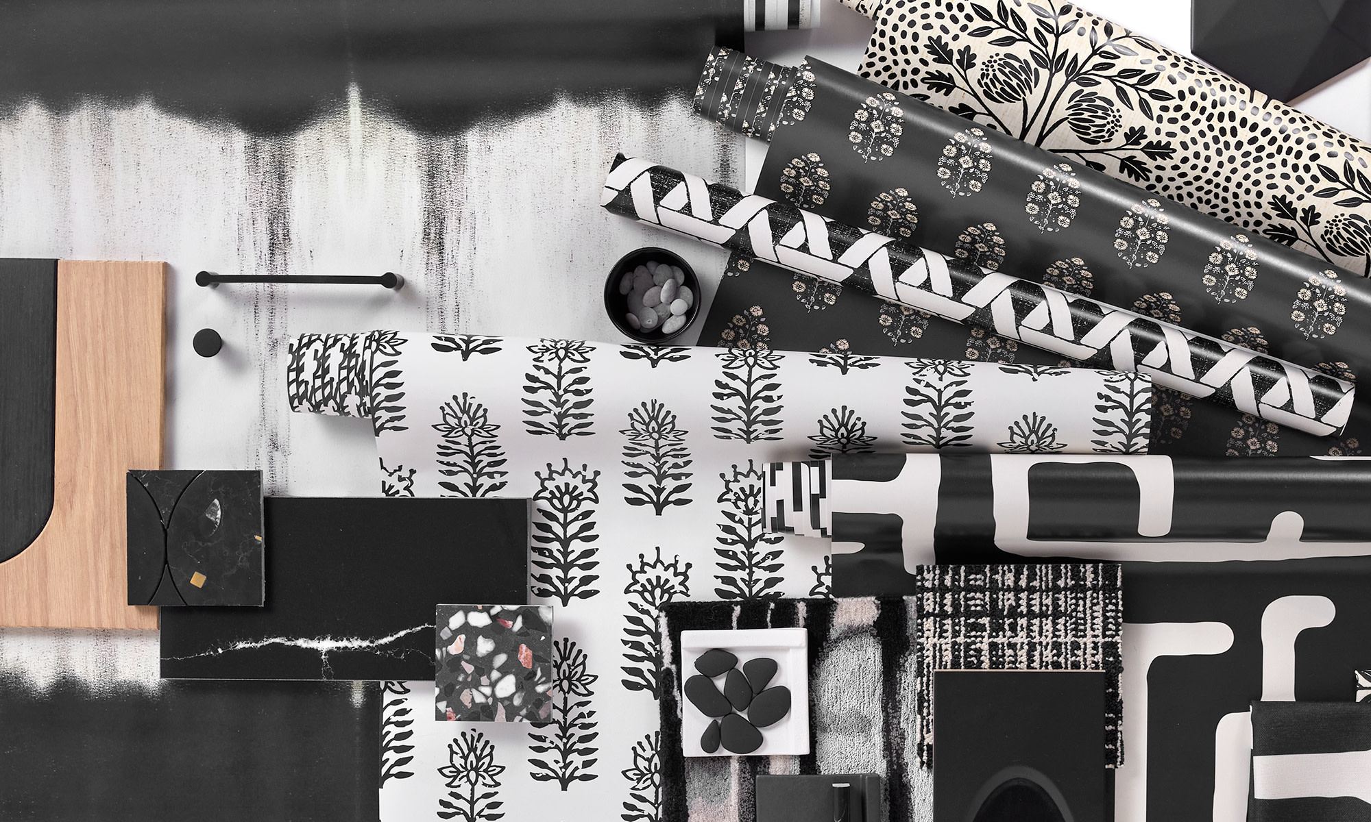 Three rolls of black peel and stick wallpapers.