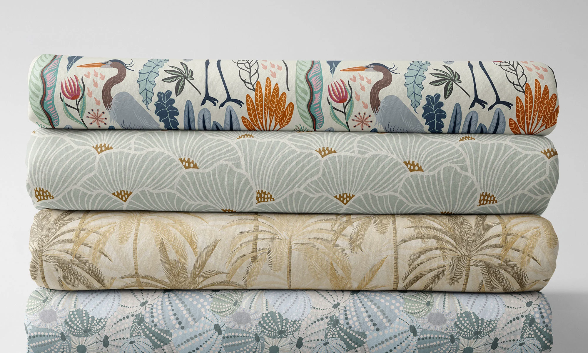 A stack of folded coastal fabric in neutral blue, gray, and beige
