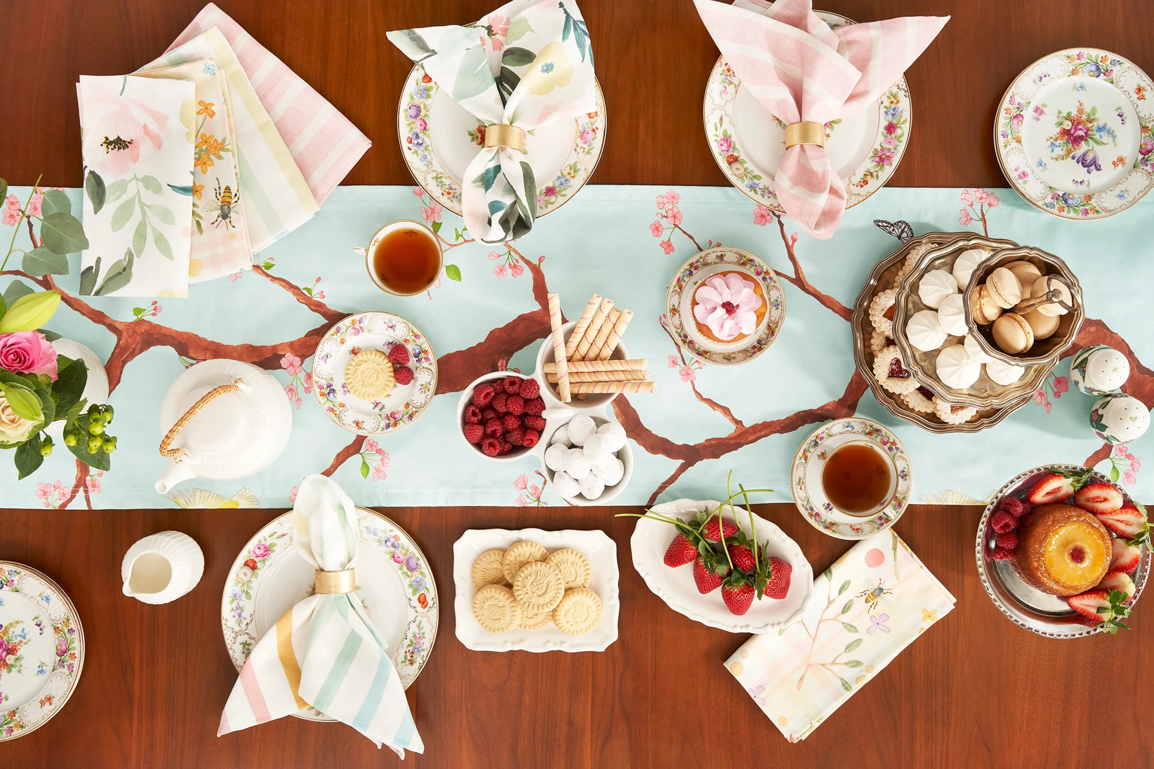 Pale pink and blue table linens on a set table.