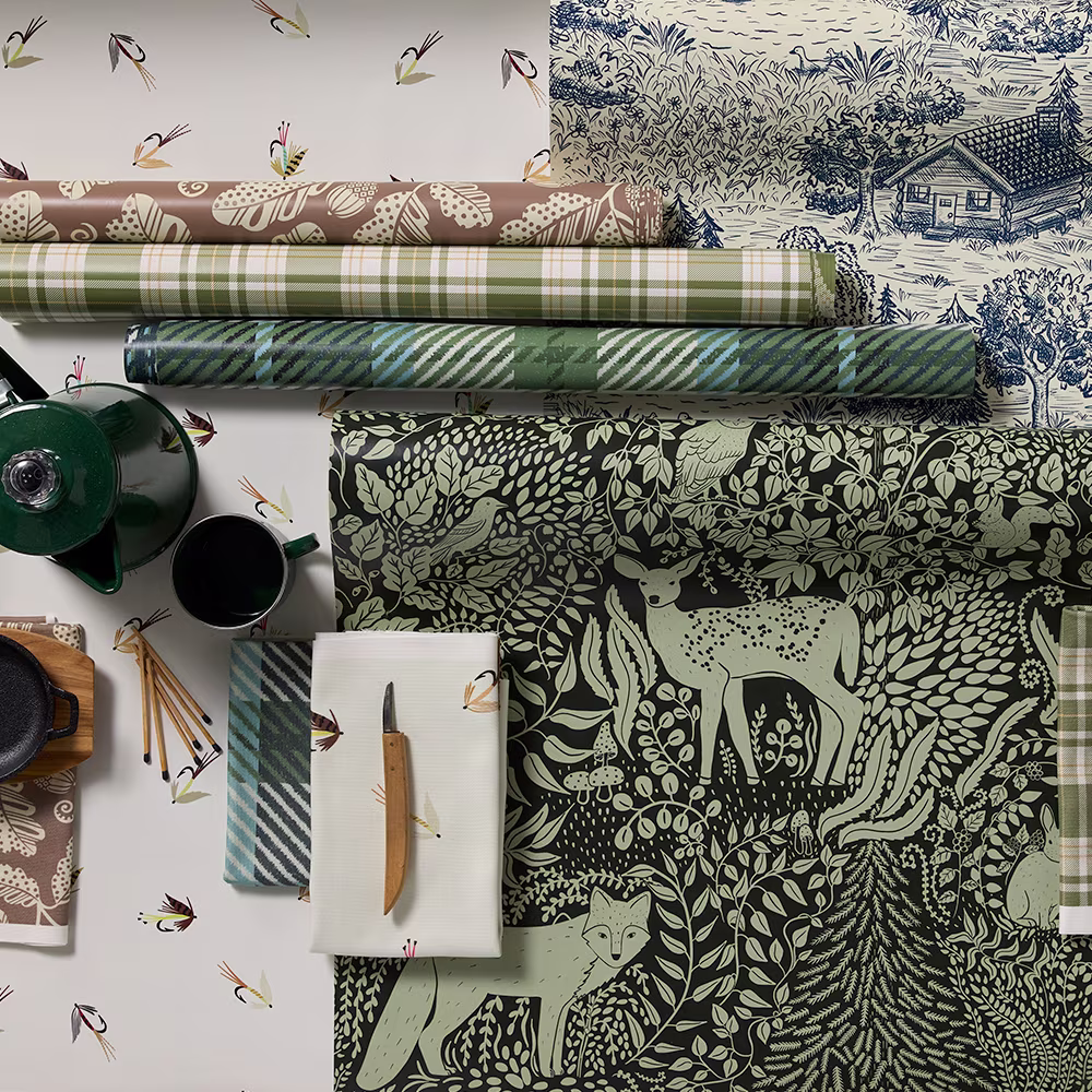Rolls of cabincore style wallpaper.