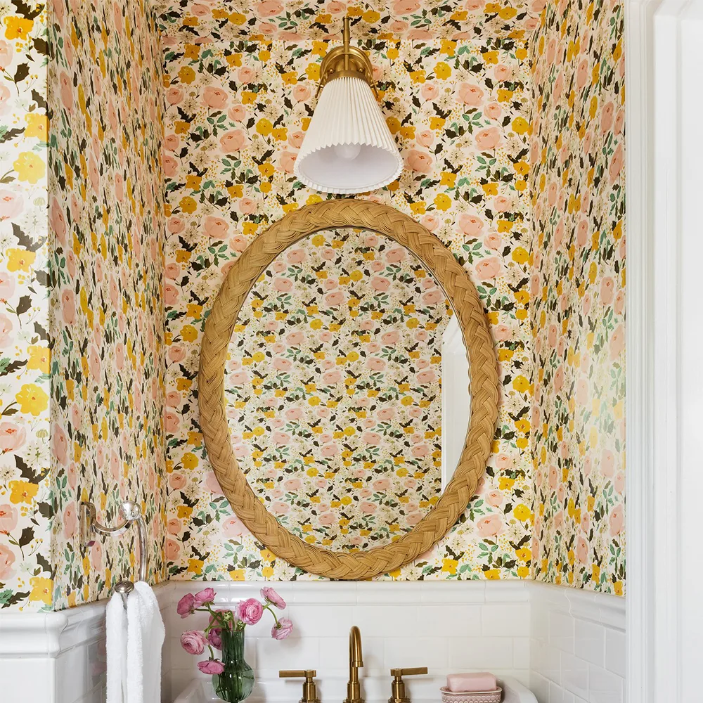 Bathroom with yellow rose floral wallpaper.