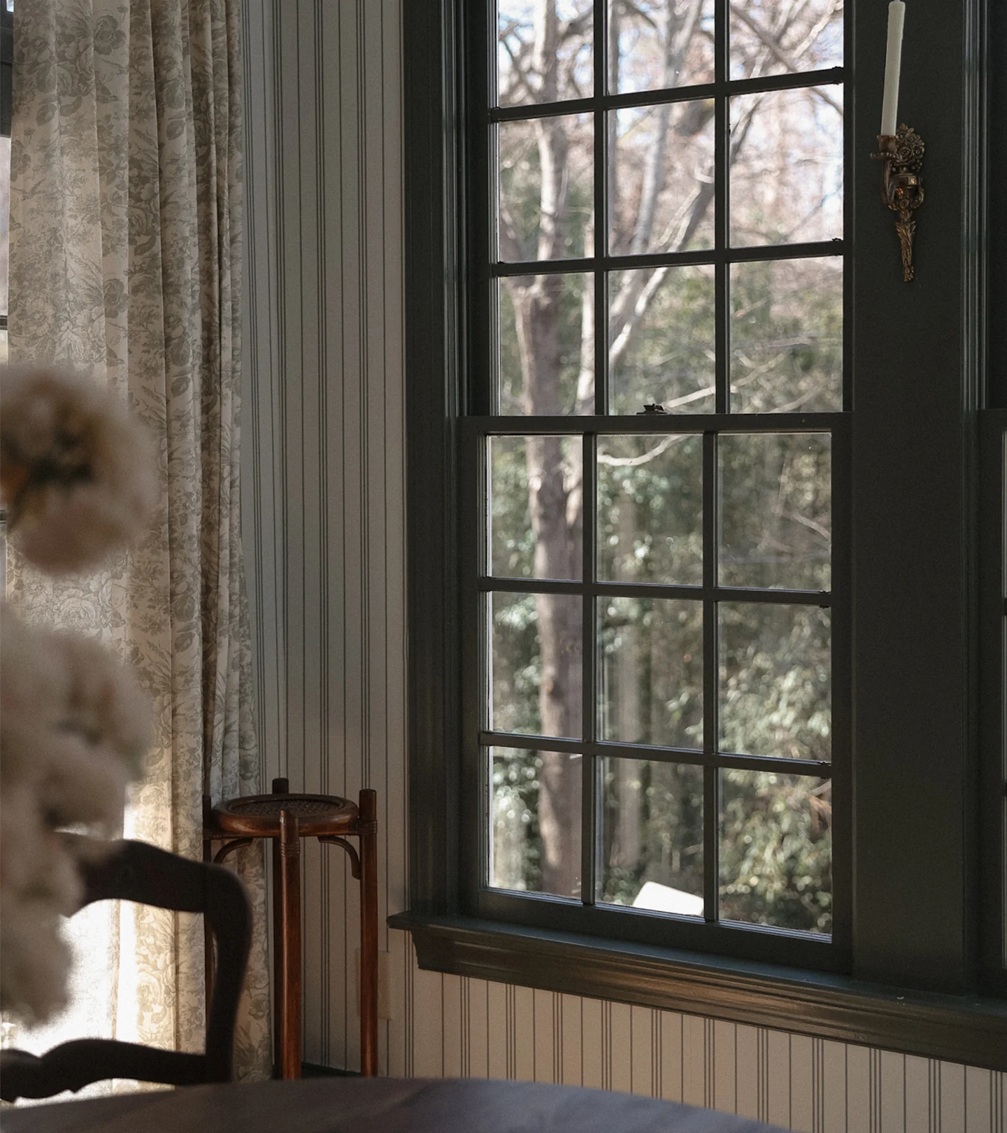 Striped wallpaper around a window in a dining room