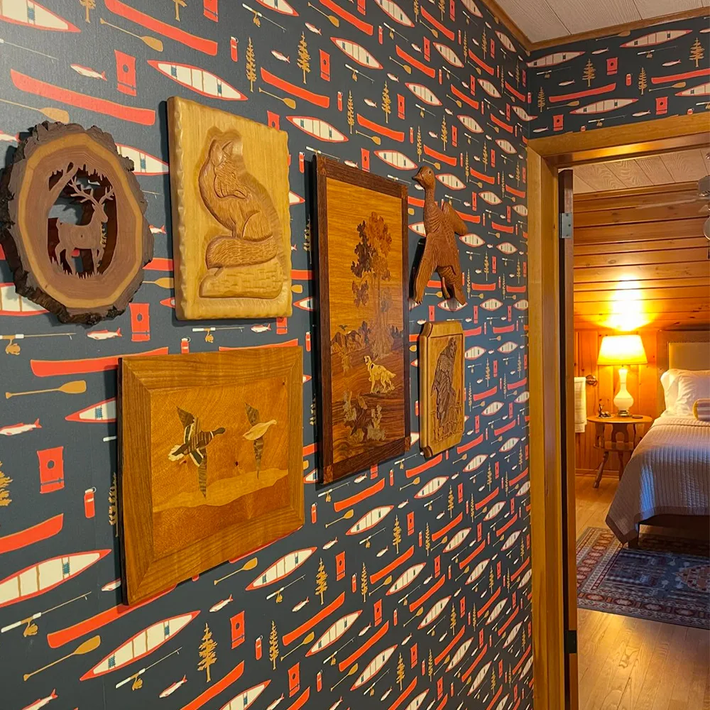 Cabin hallway with canoe wallpaper.