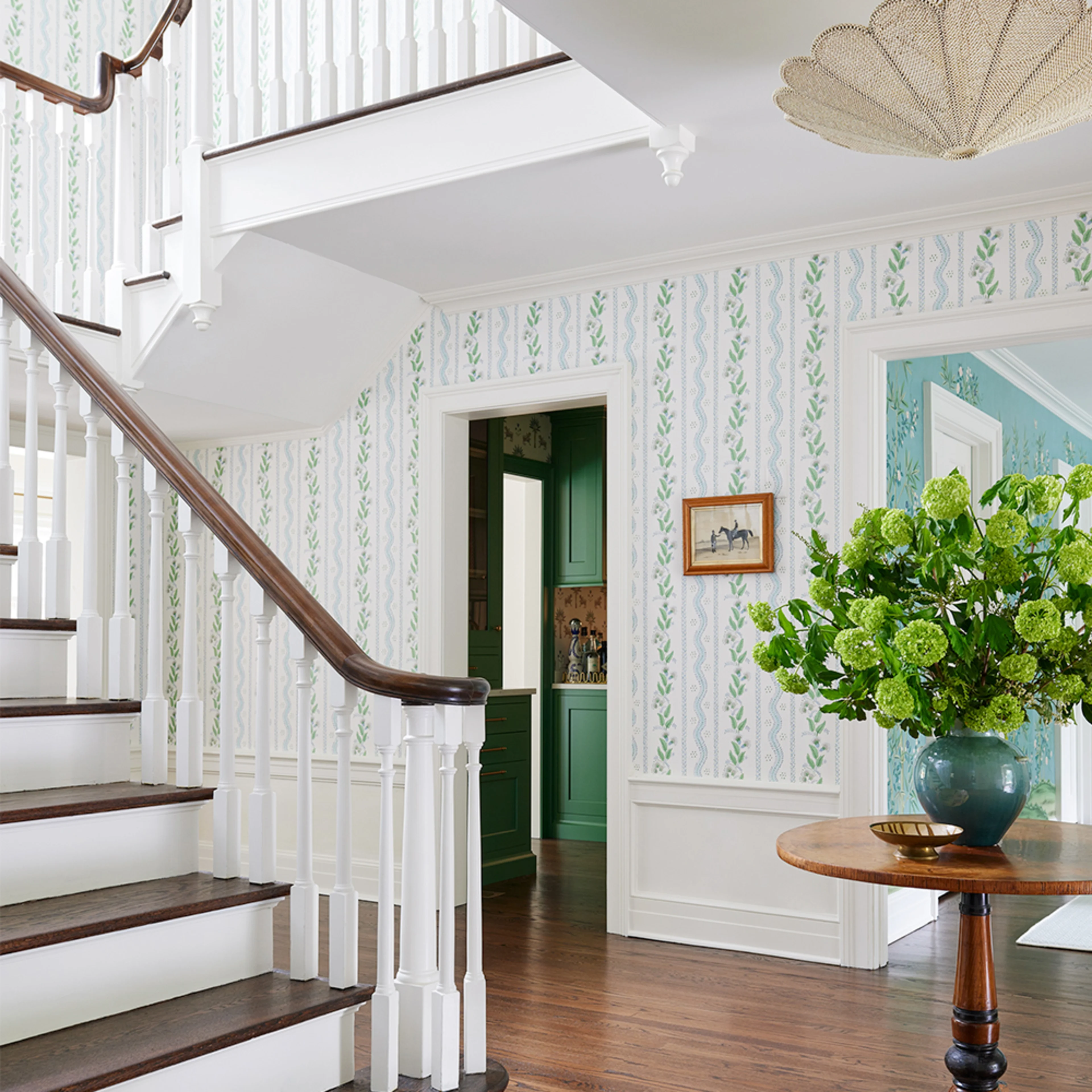 Foyer with striped wallpaper.