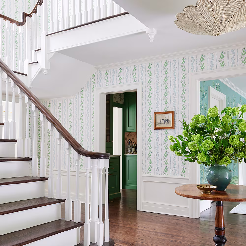 Neutral leaf wallpaper in an entryway.