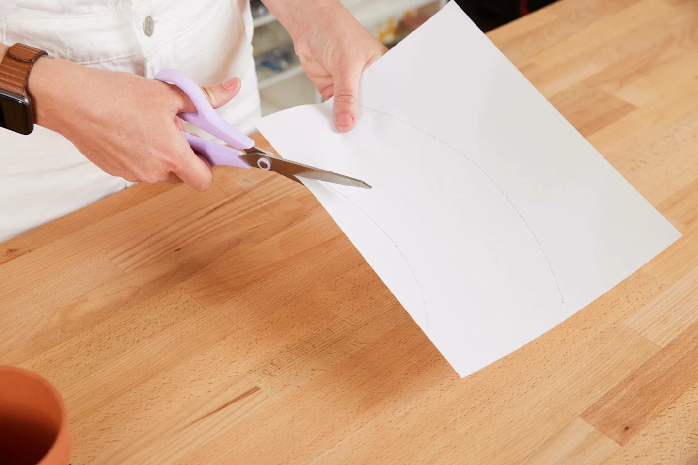 Alexa begins to cut out the paper template which has been traced onto a piece of paper.