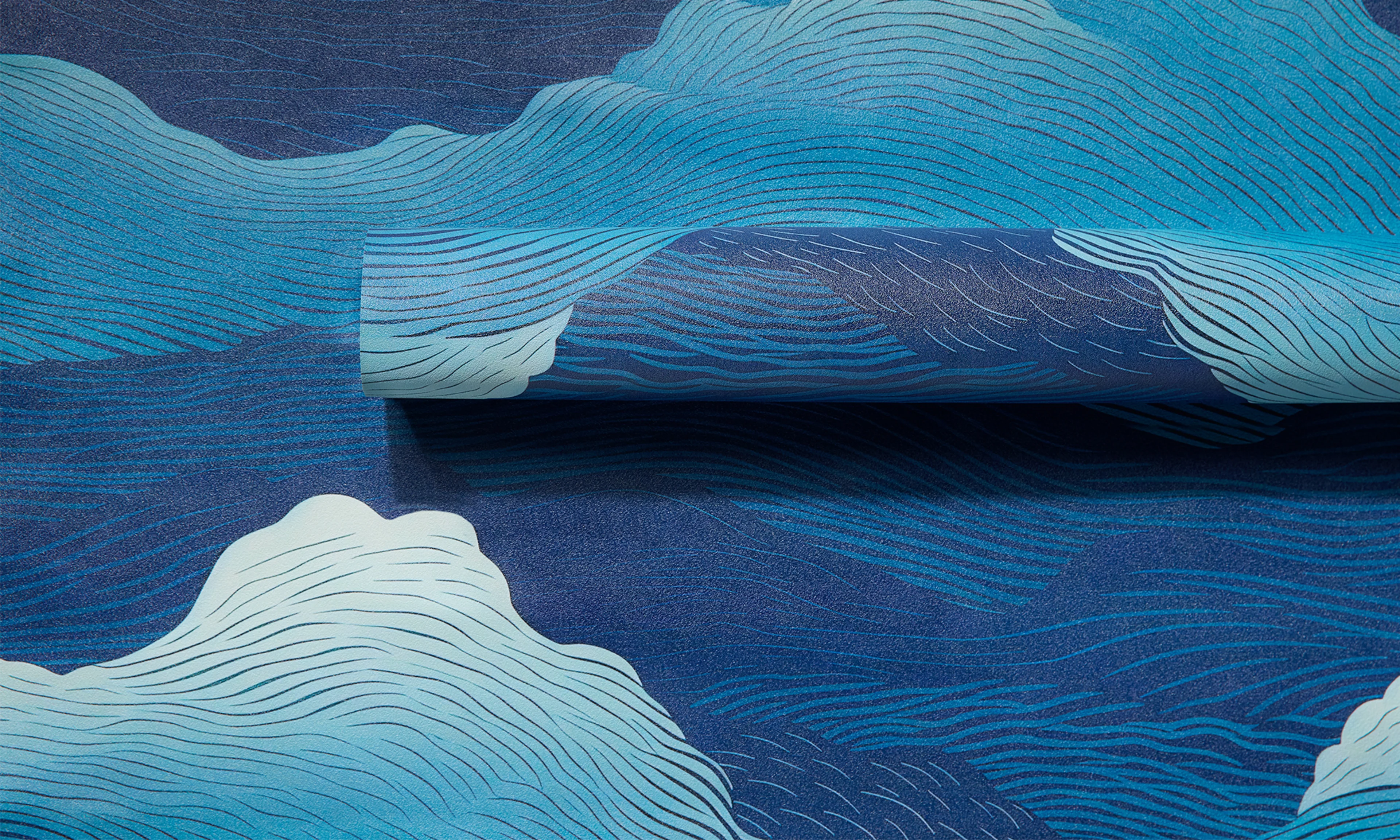 Blue abstract wave design on vinyl wallpaper roll.