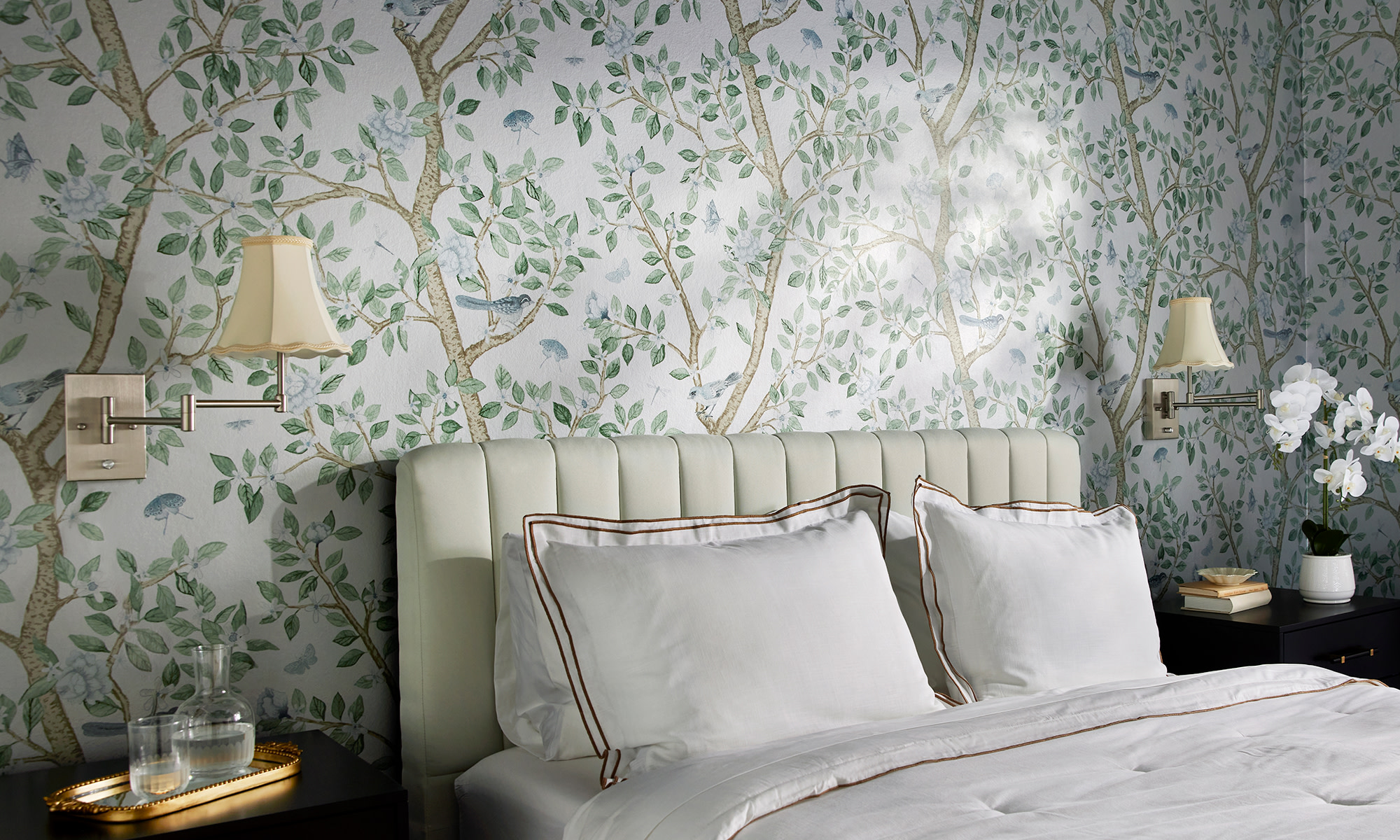 Rustic cabin bedroom with neutral floral wallpaper and christmas themed decor.