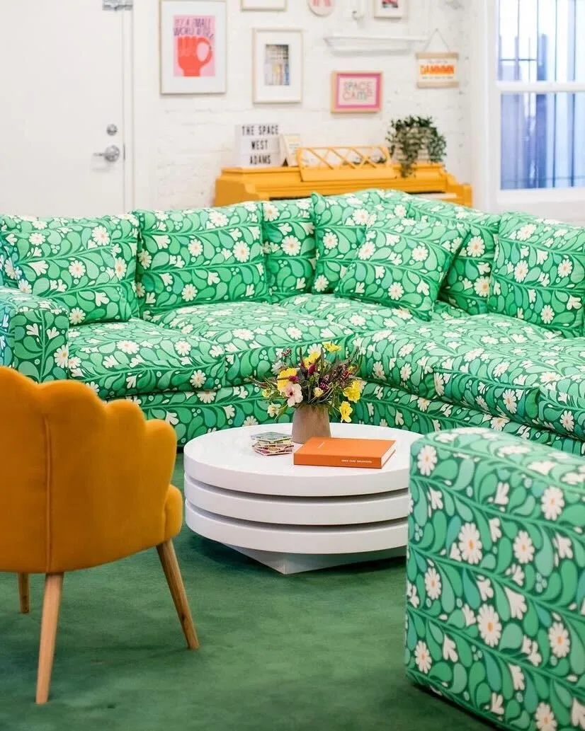 A couch with a green Cypress Cotton Canvas design