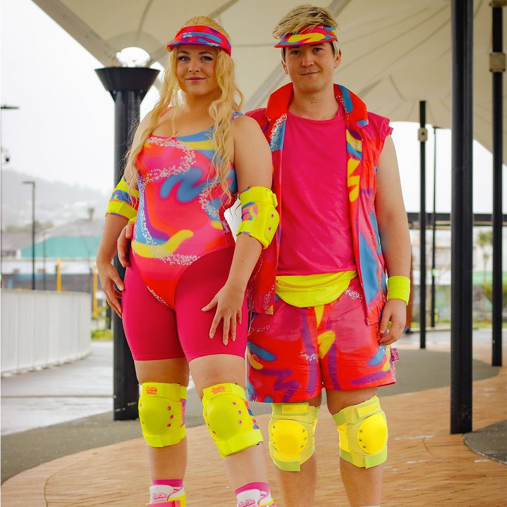 People dressed up as roller skating Barbie and Ken.