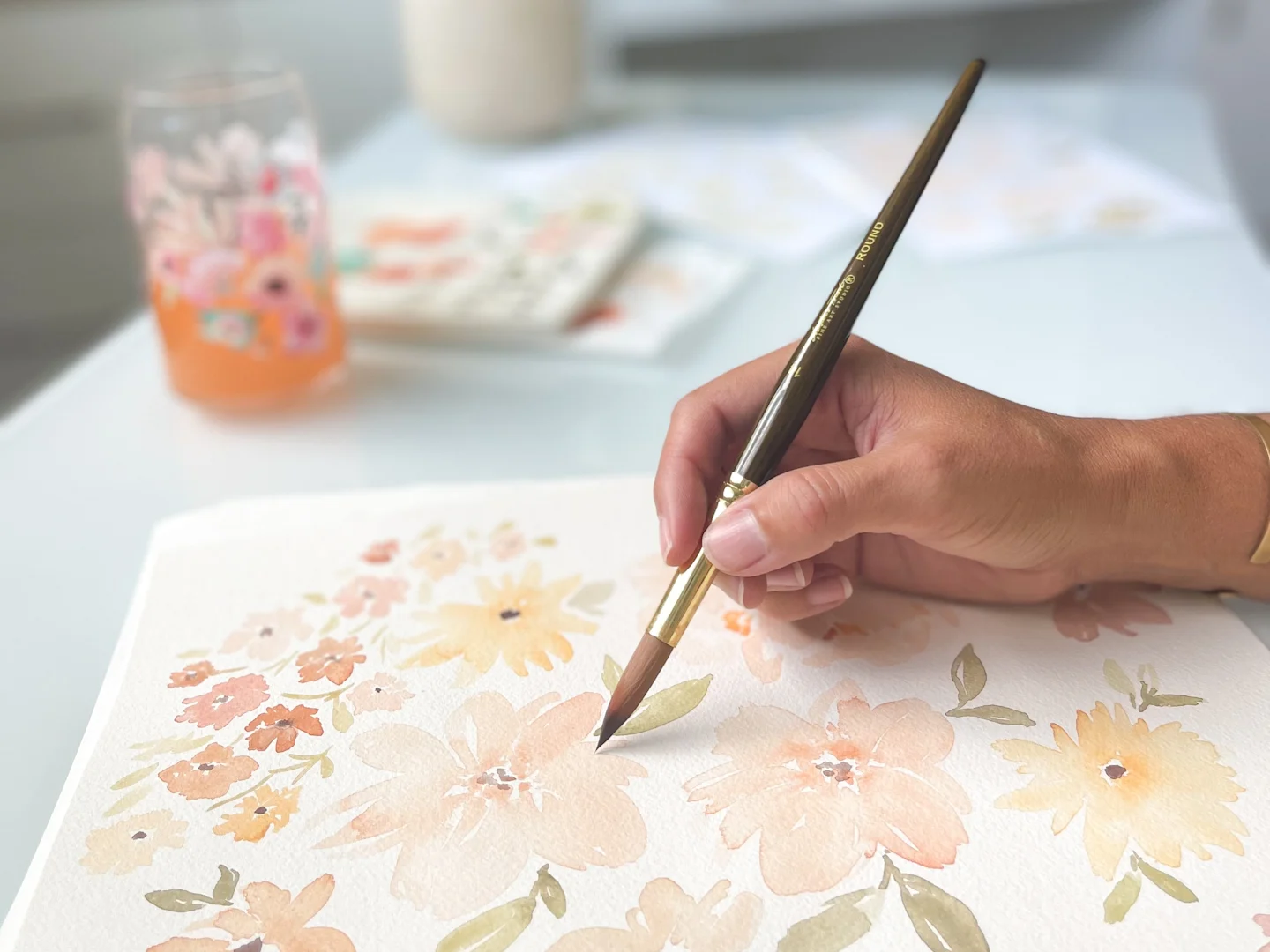 Mindy Young painting a soft watercolor floral