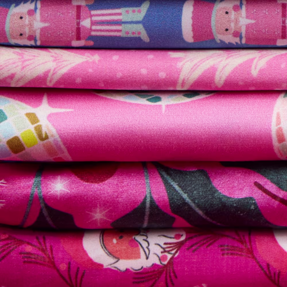 Stack of hot pink christmas fabrics