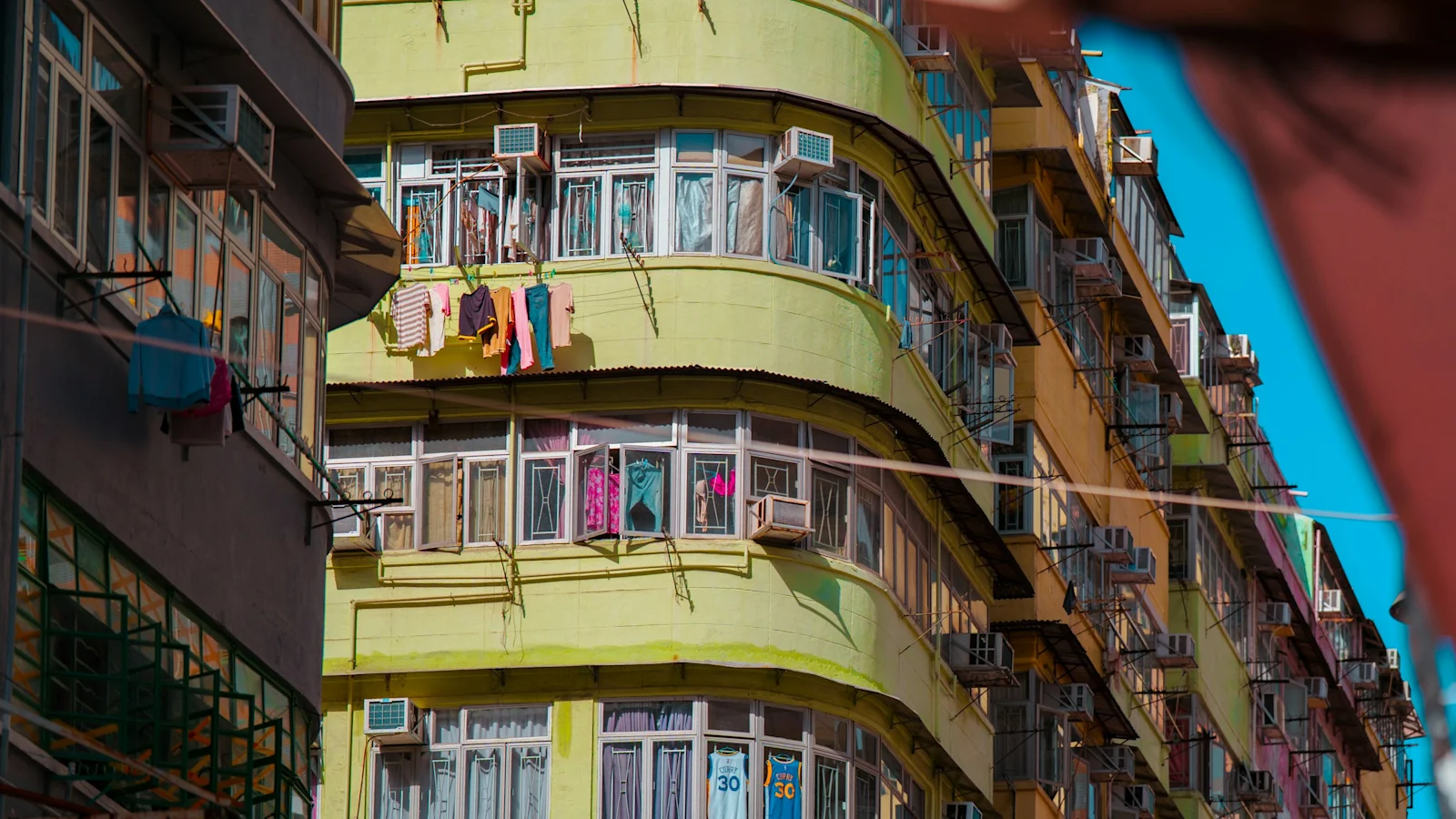 What India's record demand day actually tested. Urban residential buildings with numerous windows and air conditioners.