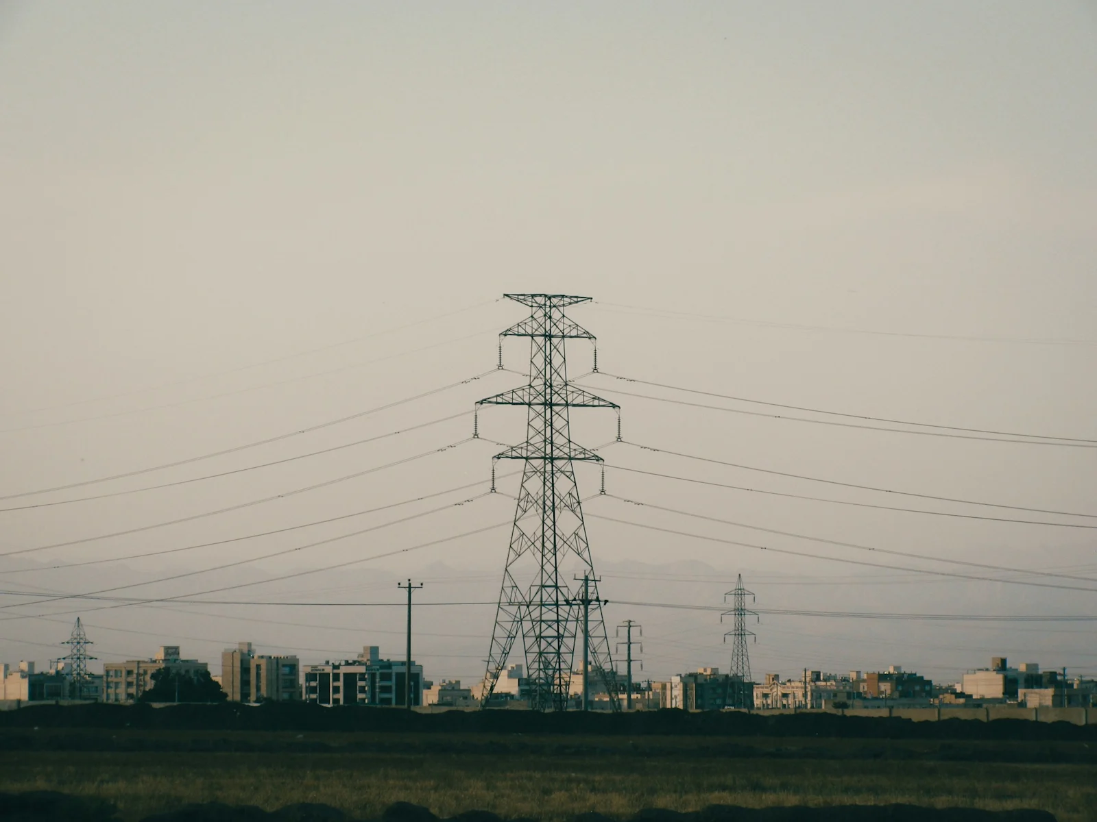 Transmission towers on the approach to a city. Headroom is a network property, not a substation property.