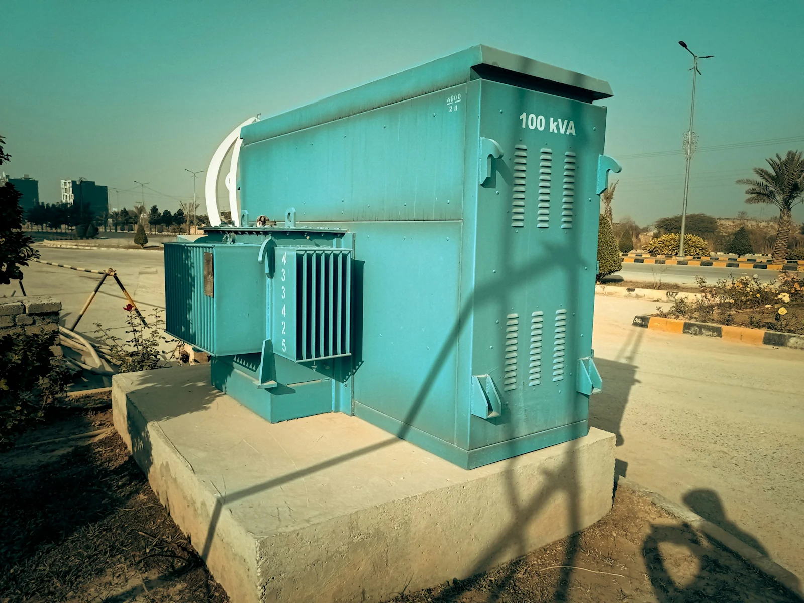 A pad-mounted transformer on an Indian roadside. Screening starts with the network asset, not the land deed.